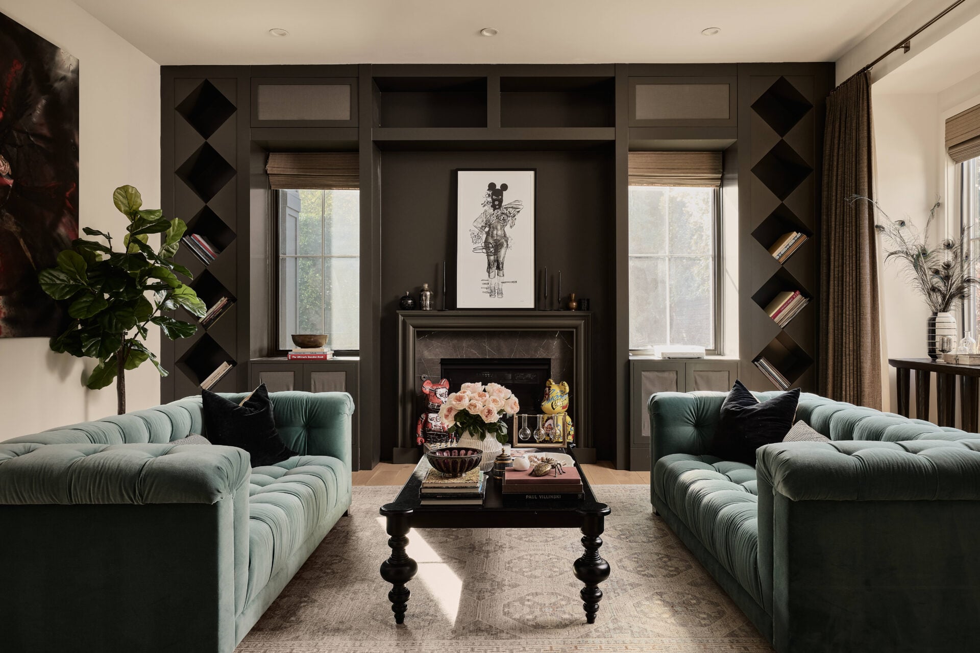 Deep green tufted sofas face each other across a dark wood coffee table.