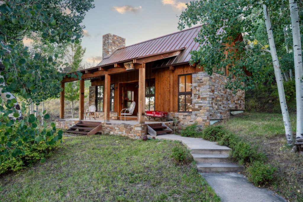 The guest house mirrors the main cabin’s rustic construction