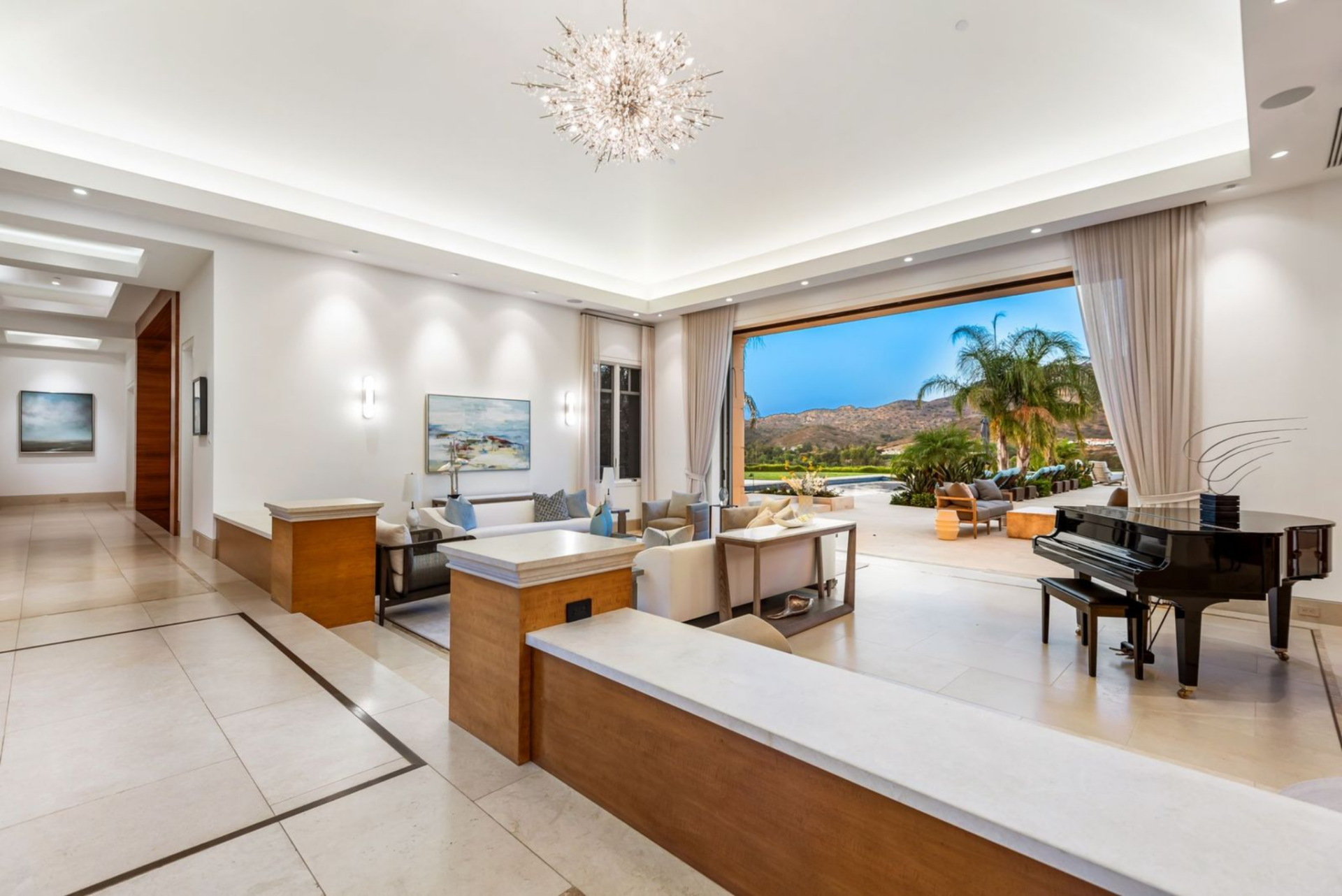 Automated pocket doors in the formal living room open to the backyard patio.