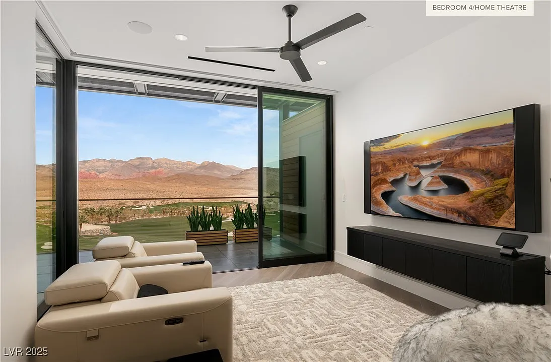 Home theater arranged around a wall-mounted screen and low, built-in media cabinetry. 