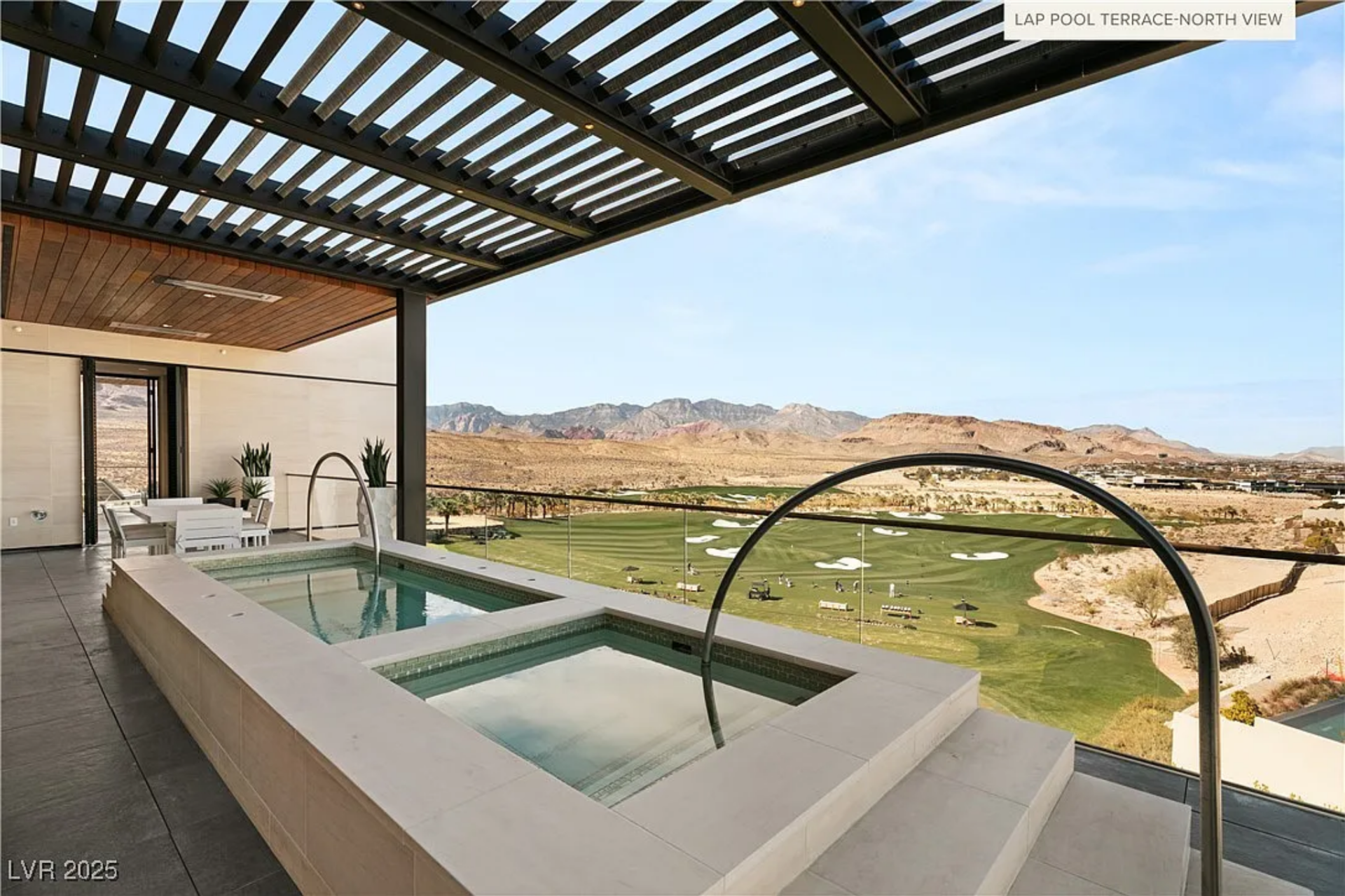 Covered terrace with a lap pool and outdoor dining table with views of golf course and mountains.