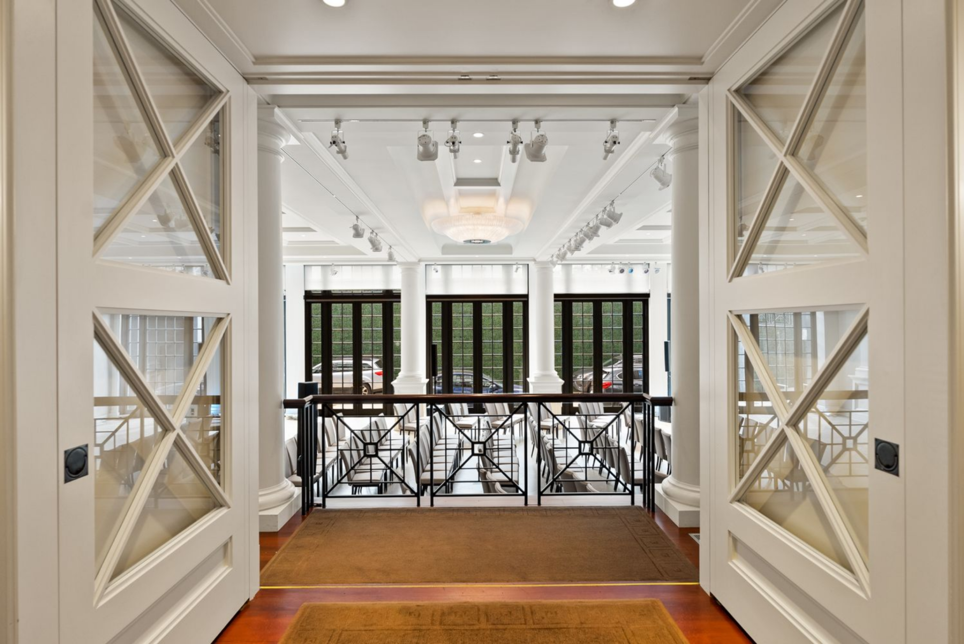 A pair of glass-paneled doors that frame a lower hall. 
