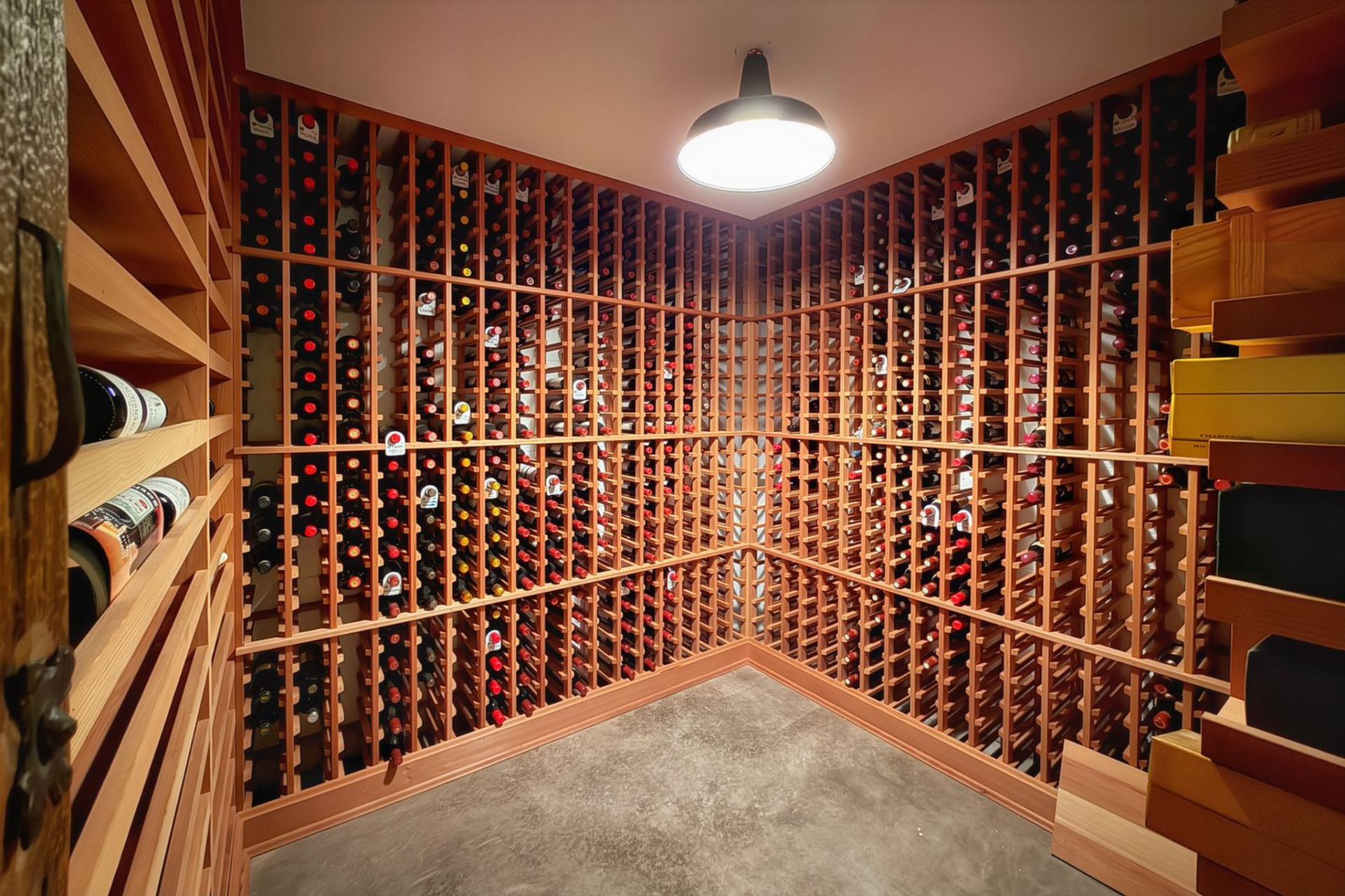 The wine cellar has floor-to-ceiling wood racking wrapping the room on all sides.