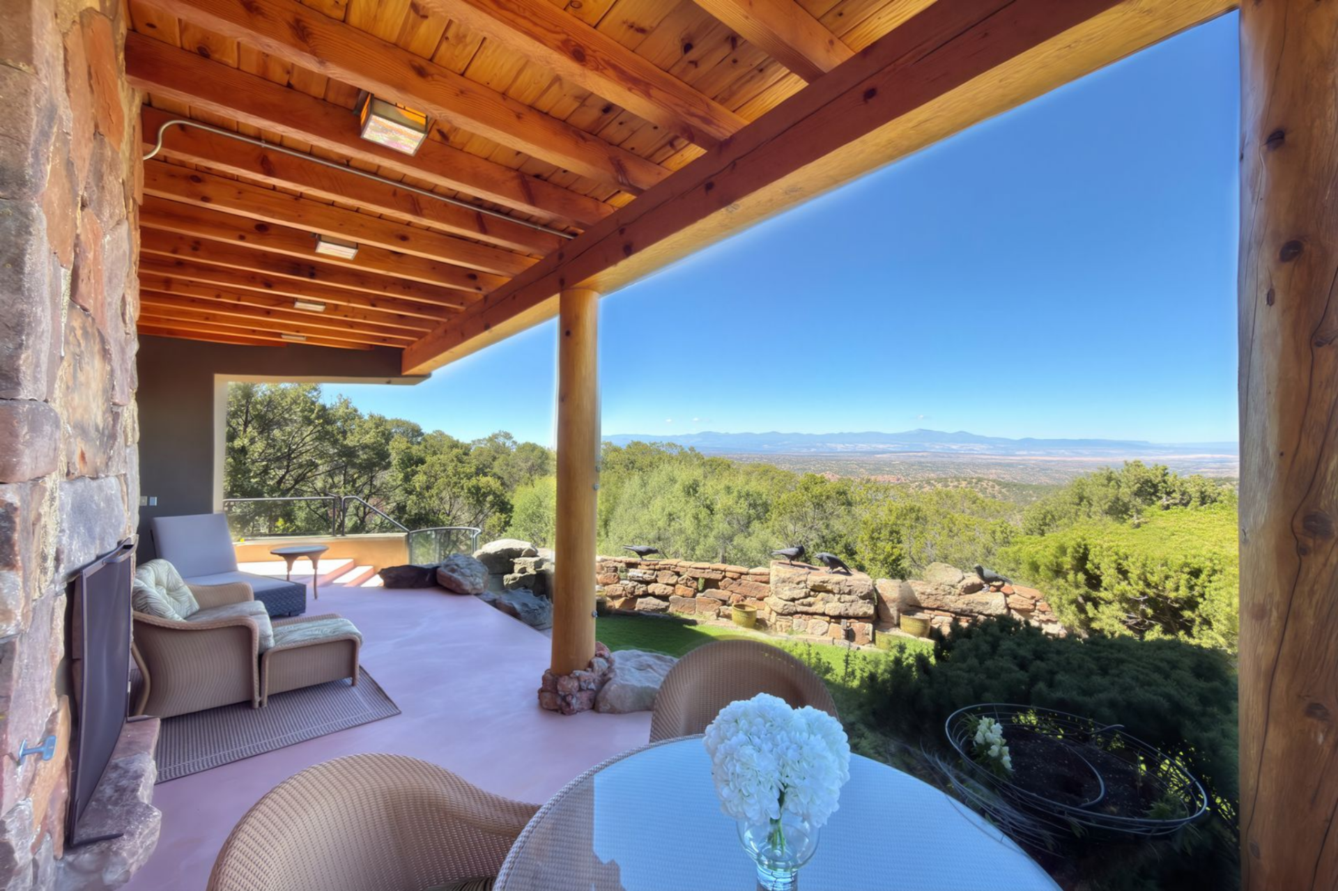 An outdoor terrace that opens to frame long views across the green landscape.