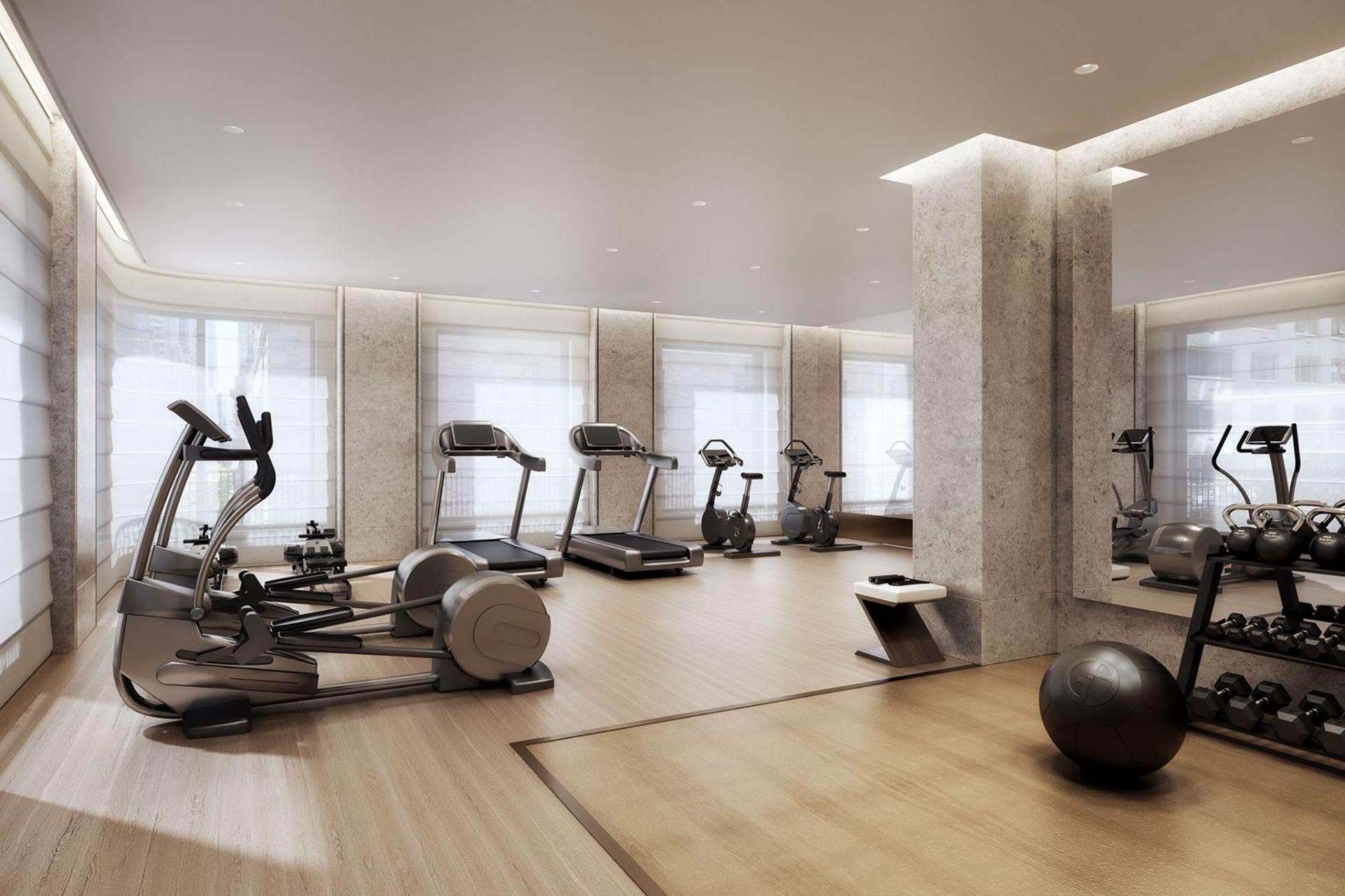 The fitness studio is designed with a clean layout, natural light, and a mix of cardio and strength equipment.
