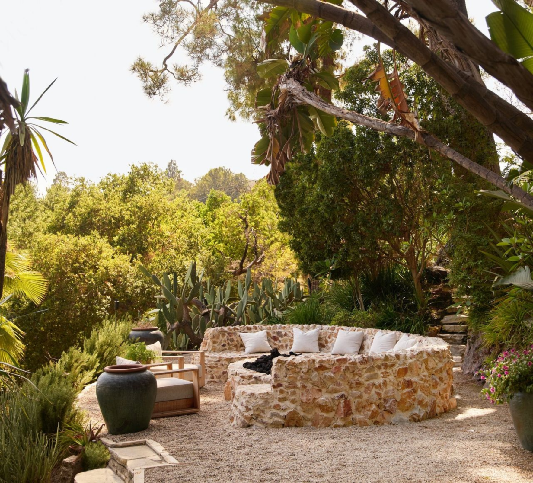 Further along the paths, a scenic fire pit sits on a gravel pad overlooking the gardens.