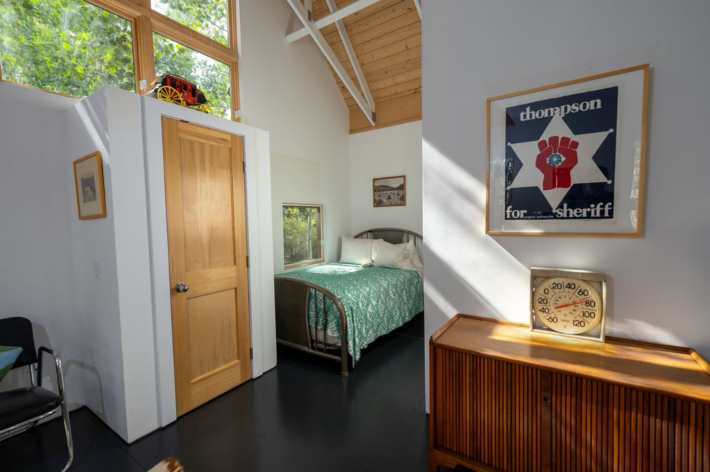 The space is finished with a mix of mid-century furniture pieces and framed artwork.