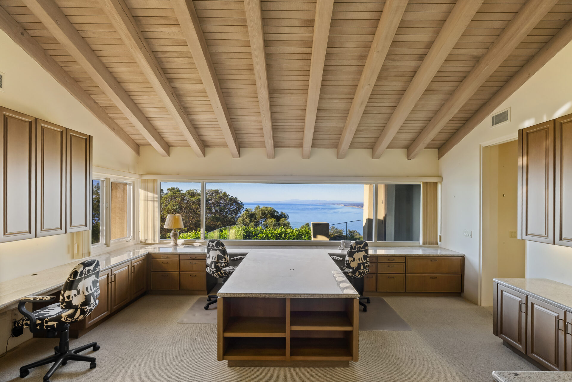 The historic bell tower and office are wrapped in the same warm wood tones from the living area and are also positioned outward toward the ocean, with a long horizontal window framing the coastline.