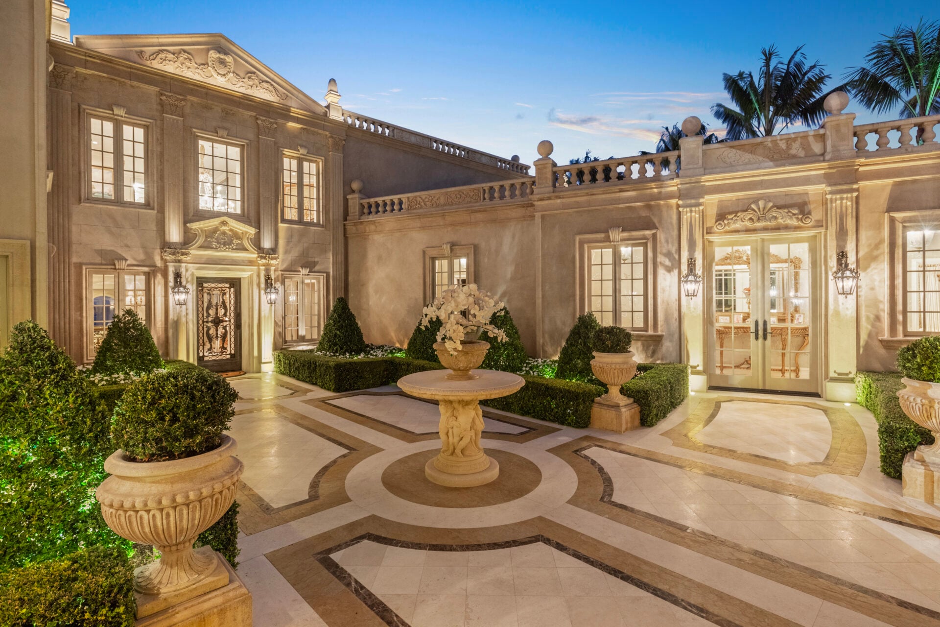 Inspired by the finest manors on the French Riviera, the design centers around symmetry, classical detailing, and layered stonework.