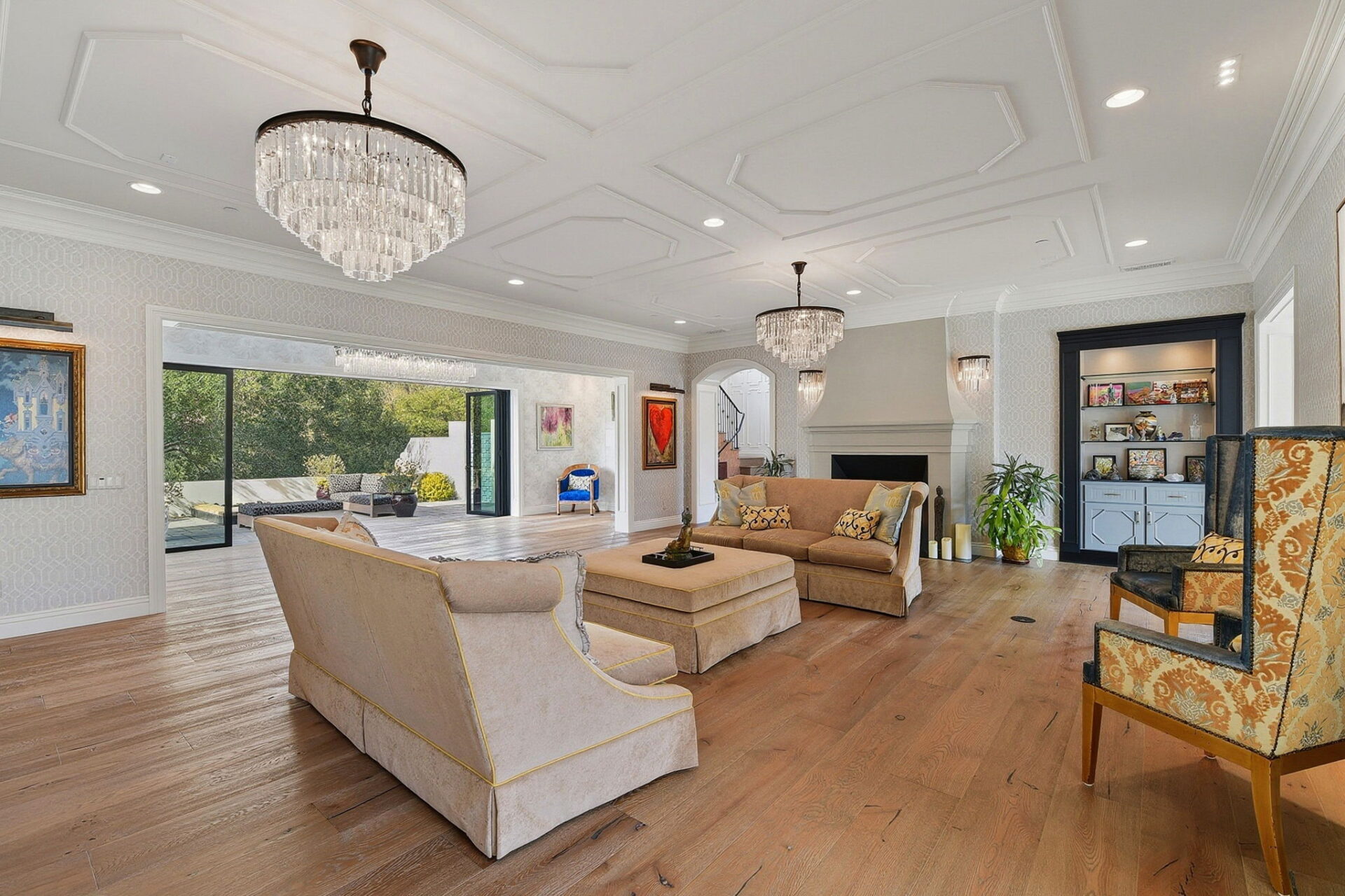 Multiple seating areas are thoughtfully arranged, from a central conversation area to additional lounge chairs positioned near the silk-wrapped fireplace and built-in display cabinetry.