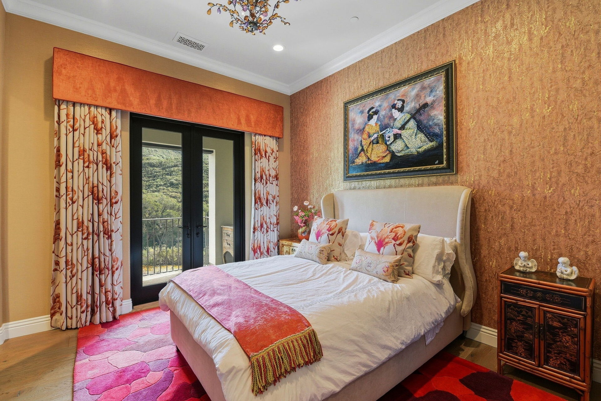 Wrapped in warm coral and gold tones, this suite makes an immediate impression with its textured metallic accent wall and bold artwork centered above the upholstered bed.