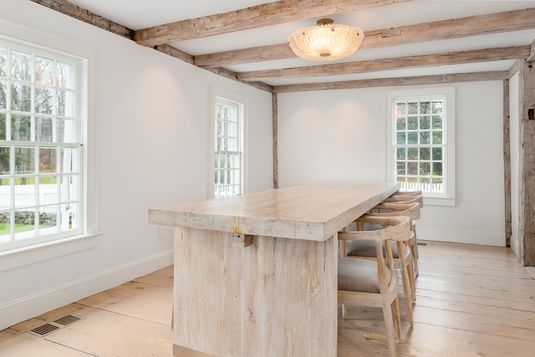 Through the side open archway, the dining area sits comfortably within its own space, positioned beneath the beams in the corner of the home to take full advantage of the natural light.