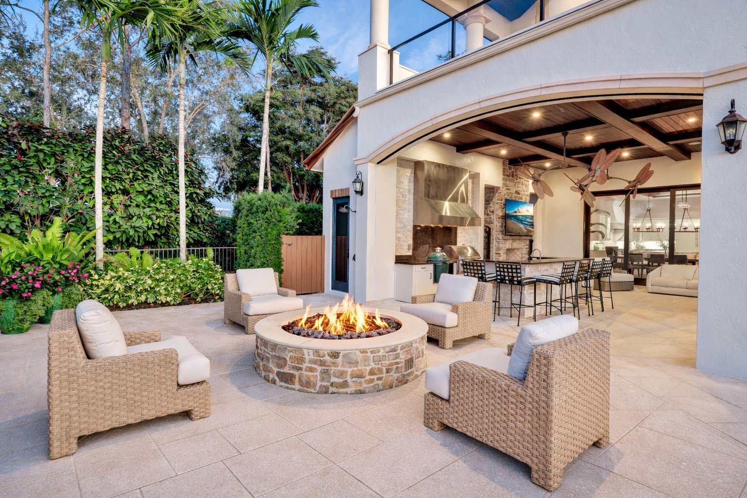 The space finishes off with a dedicated fireplace lounge, where woven seating circles a stone fire feature just outside the kitchen.