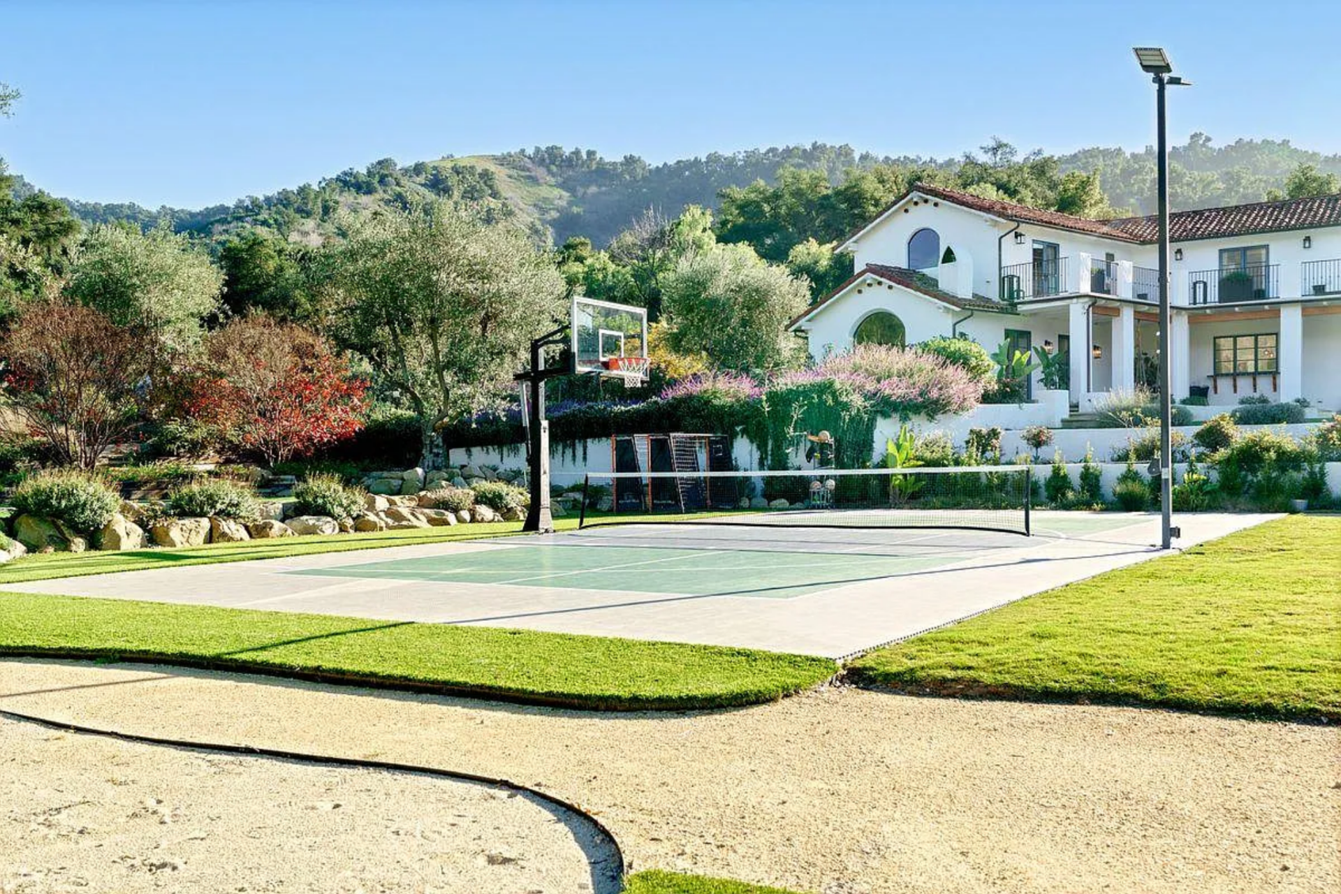 A custom putting green sits along a gravel path, offering a low-key practice spot woven into the natural setting.
