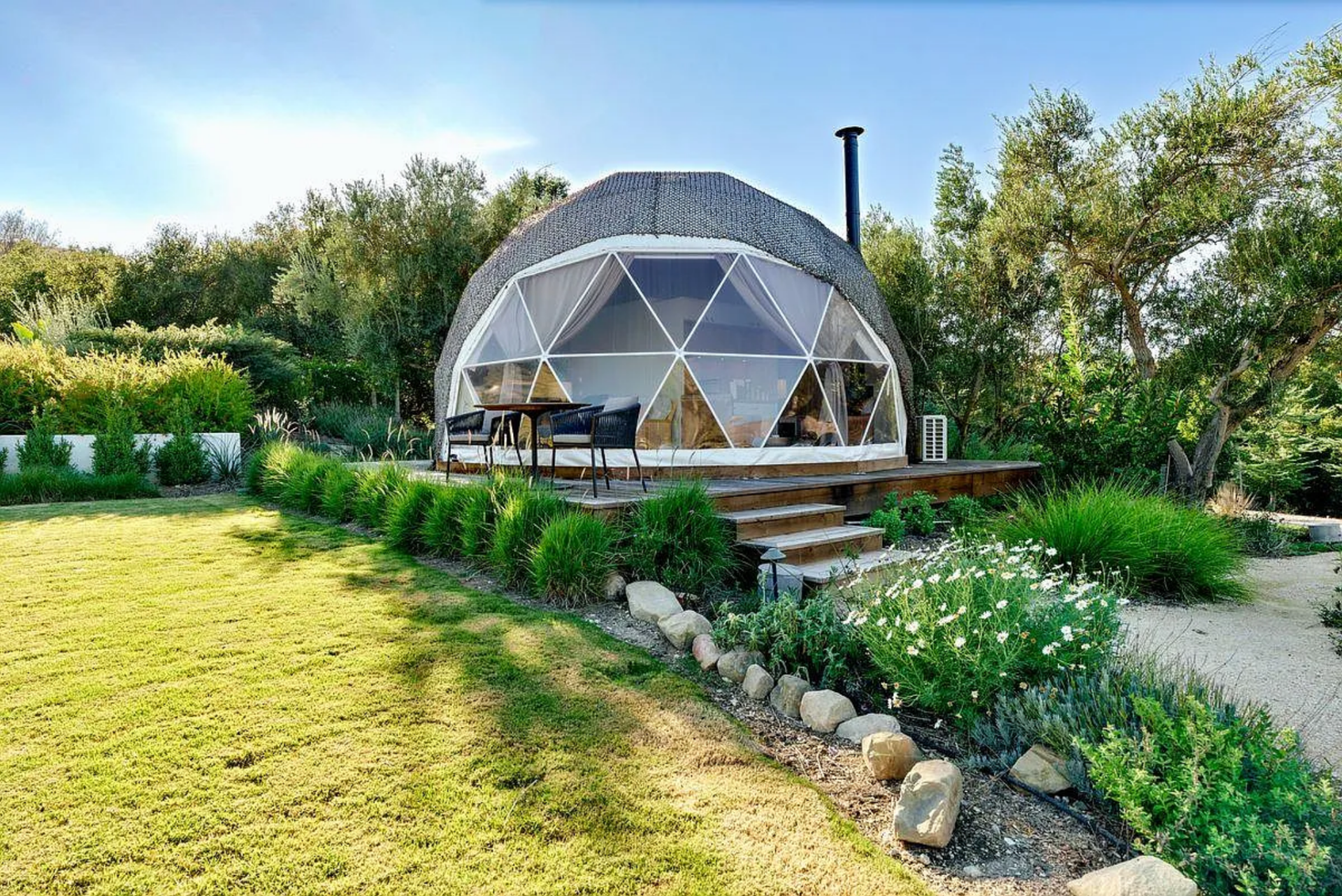 The geodesic dome serves as a flexible structure for yoga, meditation, or overflow guest use with its transparent panels.