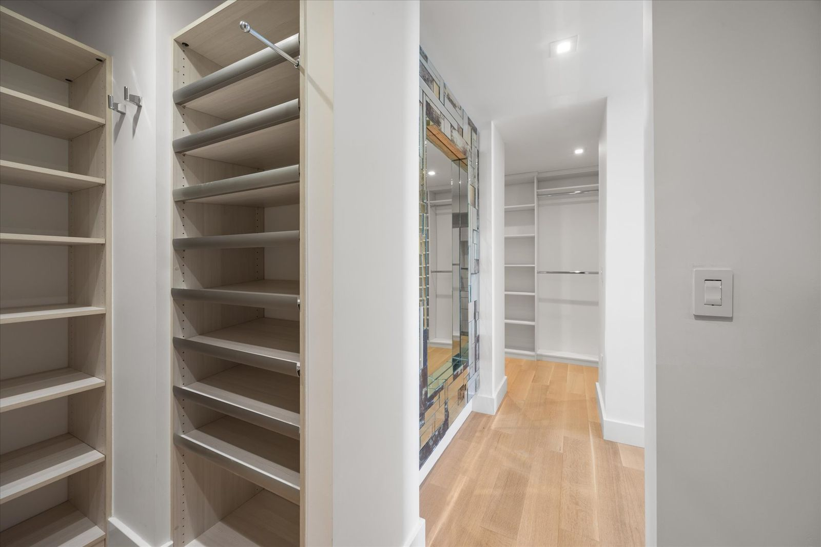 The closets are laid out as rooms of their own rather than secondary spaces, with even lighting and wide circulation paths that make them feel intentional and easy to use.
