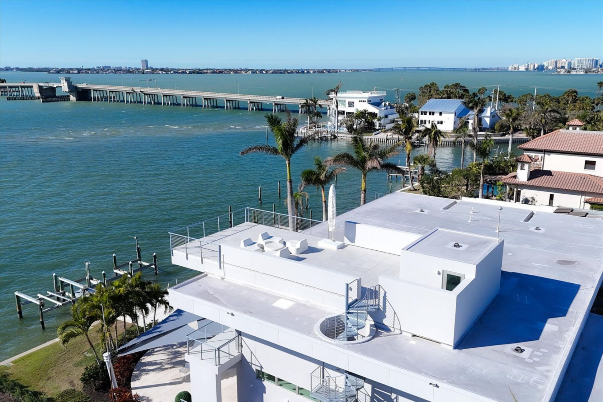 Reached directly by elevator, the rooftop deck opens into a broad, elevated entertaining space with uninterrupted water views in multiple directions. 