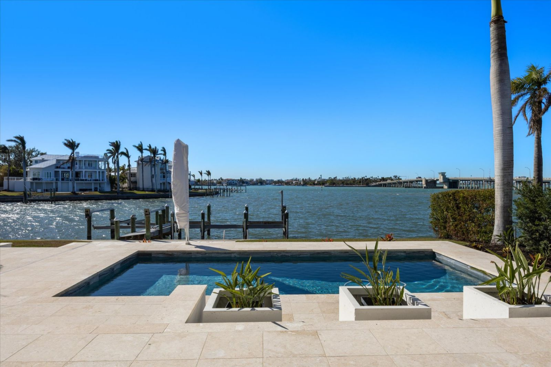 Set closest to the water, the heated pool and spa are framed by clean travertine lines and integrated planters, keeping the focus on the bay. 