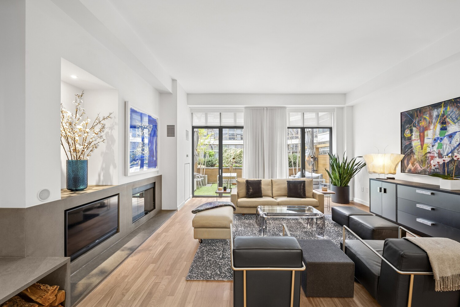 Heading upstairs, the second level opens directly into the home’s main entertaining floor, starting with a long, light-filled living room that runs toward a private terrace at the far end.