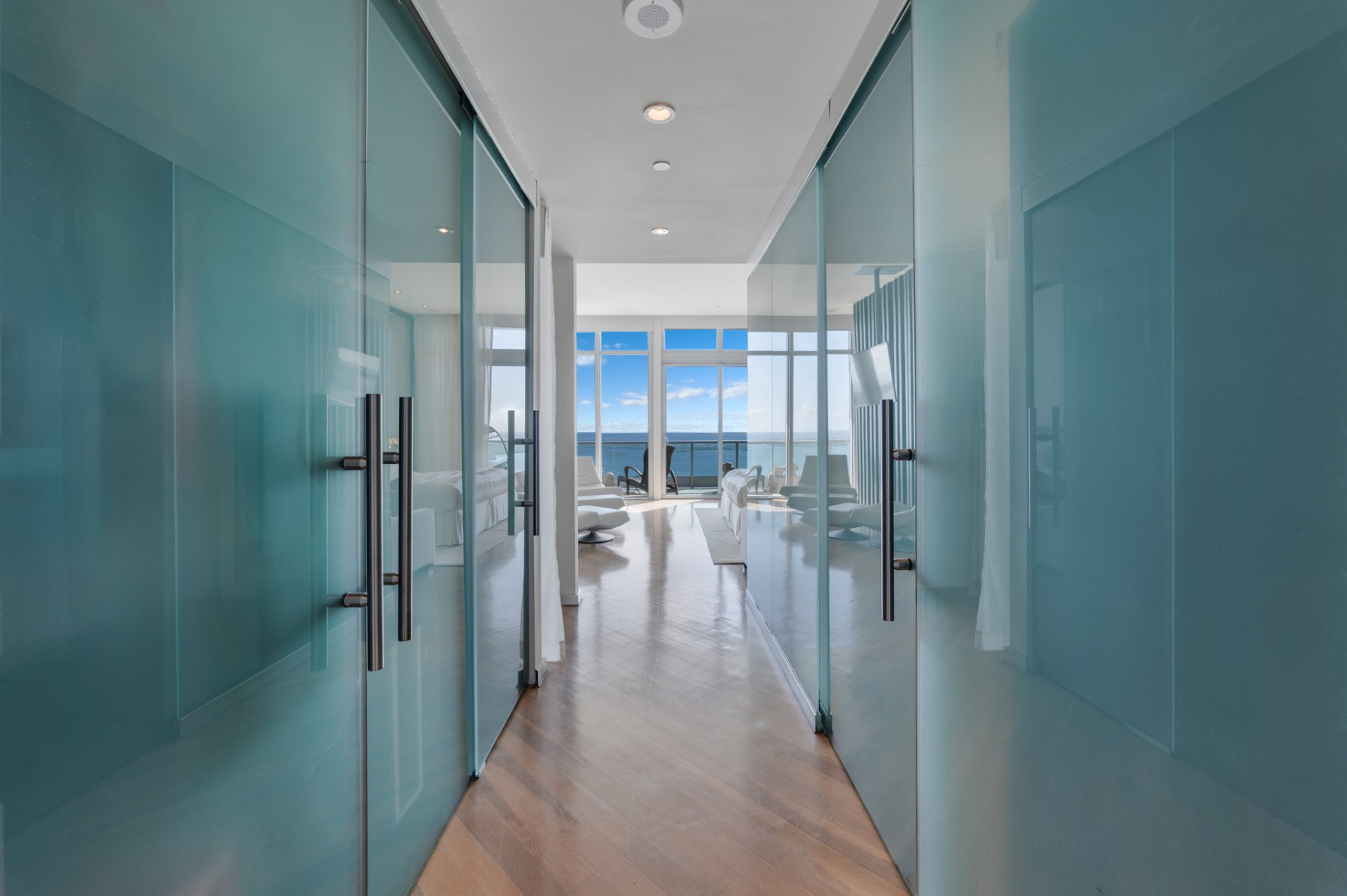 A corridor lined with frosted glass doors.
