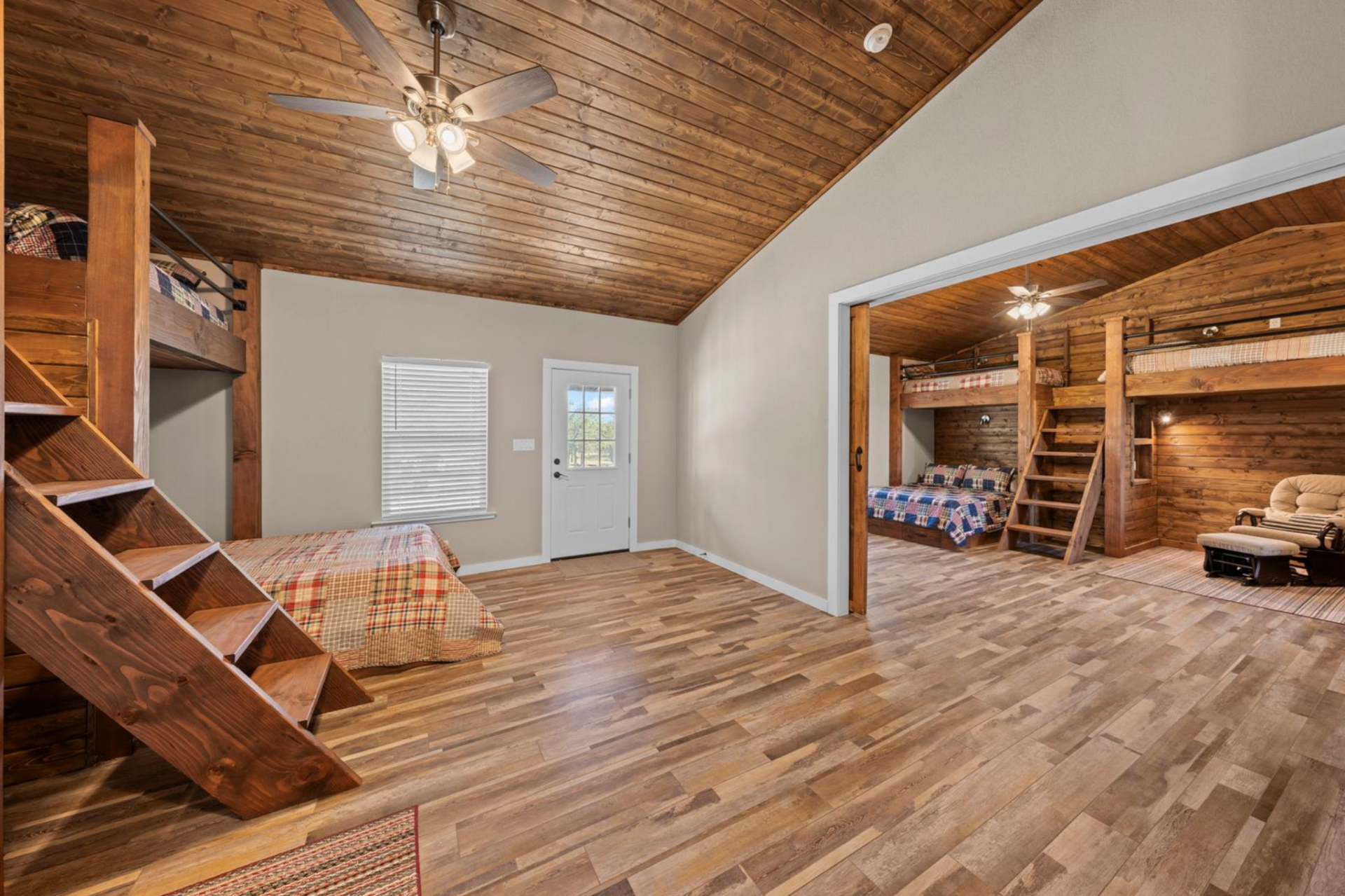 Inside, the design leans fully into its lodge-inspired setting, with warm wood walls, pitched plank ceilings, and durable flooring built to handle boots after a day outdoors. 