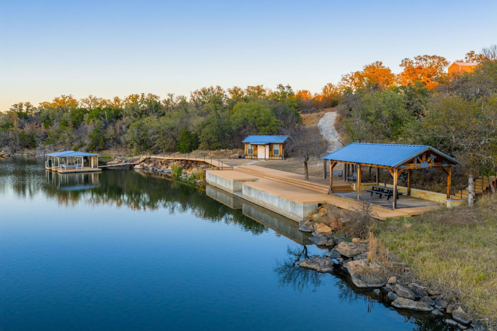 Right on the water, a covered dual-slip dock provides convenient access for small watercraft and fishing gear, reinforcing the ranch’s setup for easy, everyday lake use.