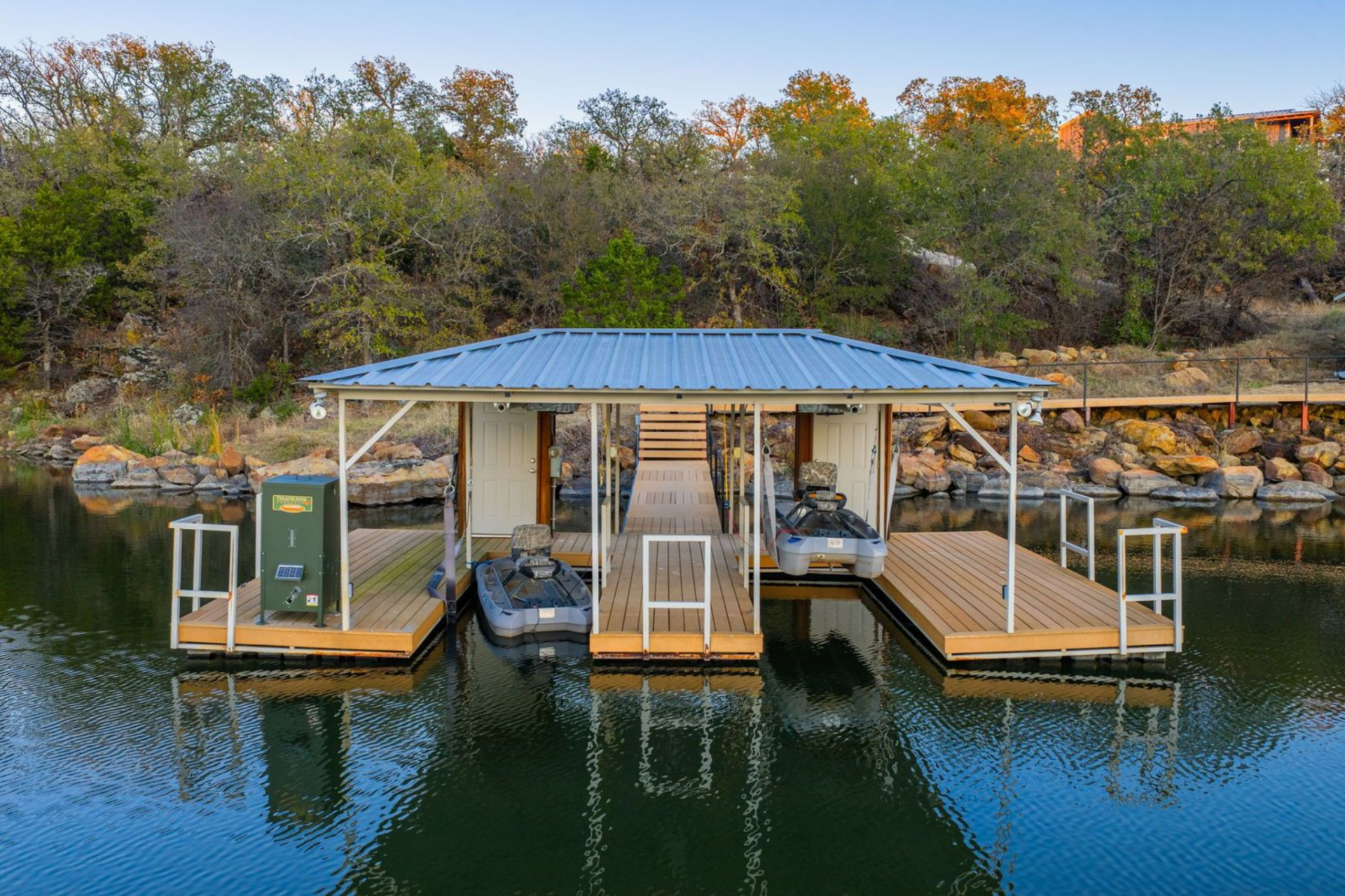 Right on the water, a covered dual-slip dock provides convenient access for small watercraft and fishing gear, reinforcing the ranch’s setup for easy, everyday lake use.
