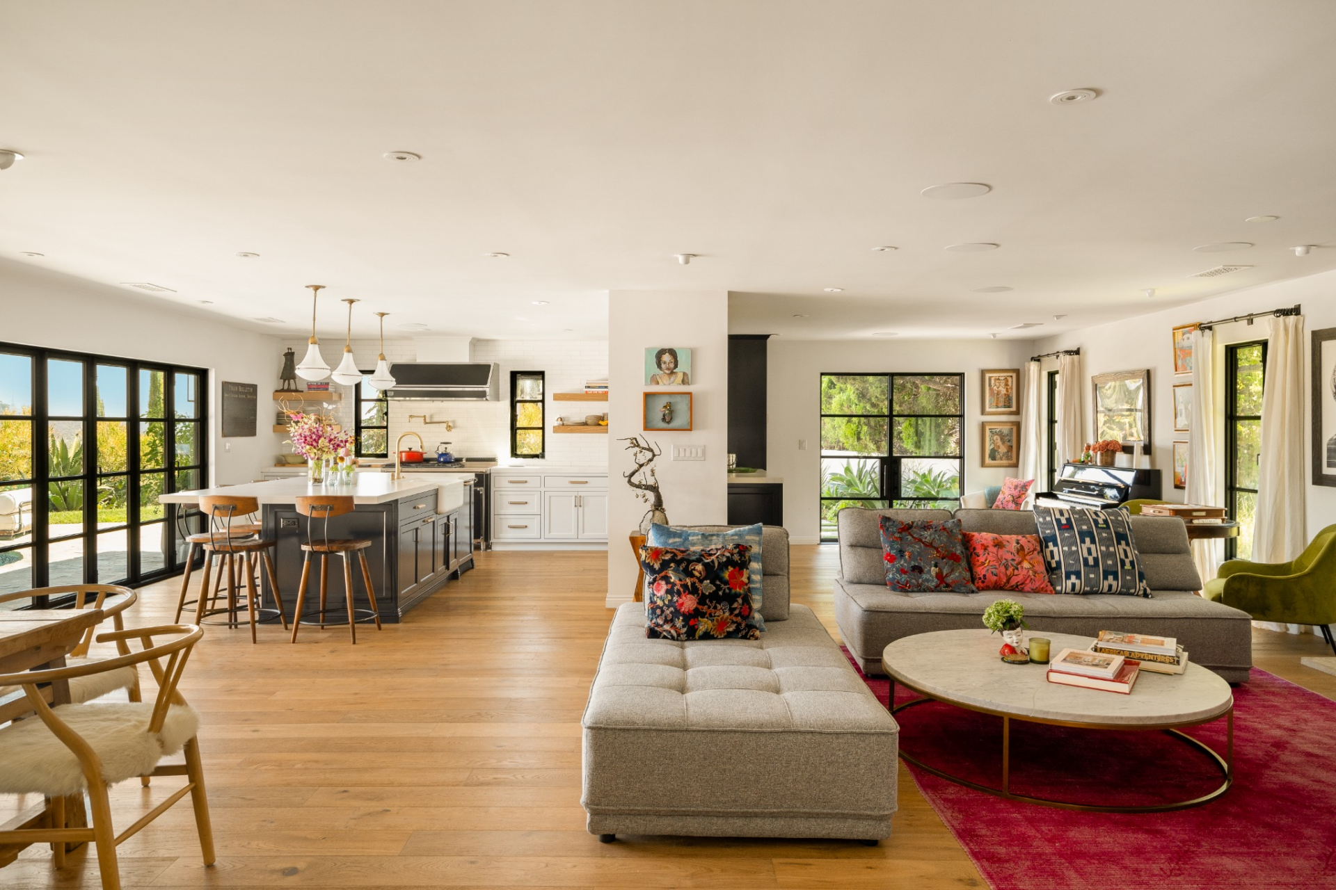 An open floor plan welcomes you into the bright and airy interiors with natural light pouring in through retractable accordion doors and windows.