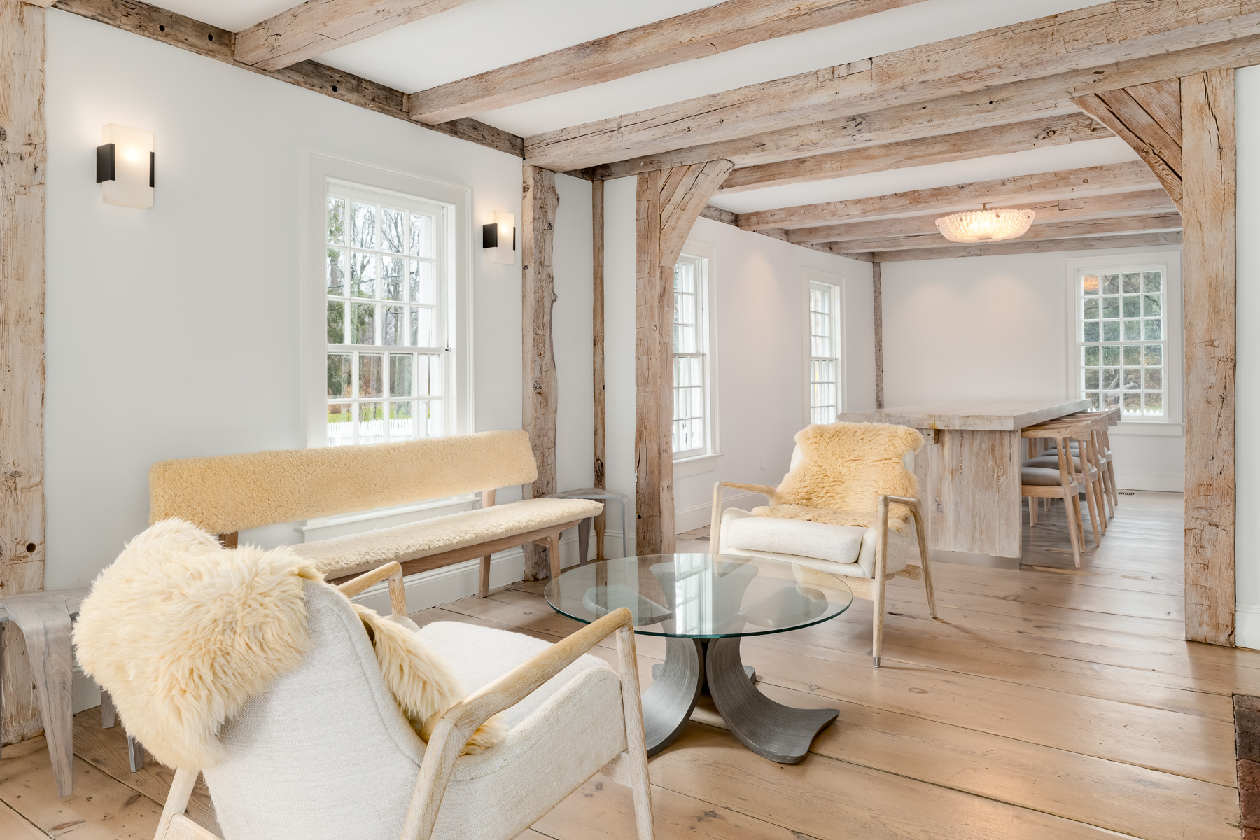 Down the hall, the home opens into a combined dining room and family room that continues the same historic framework while shifting into a more communal setting. 