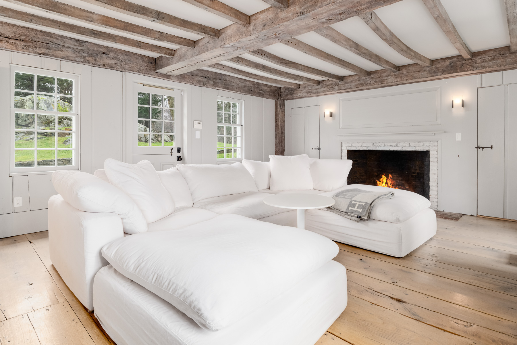 On one wall, another preserved fireplace keeps the space grounded in the home’s original character while making the space even cozier for movie nights.