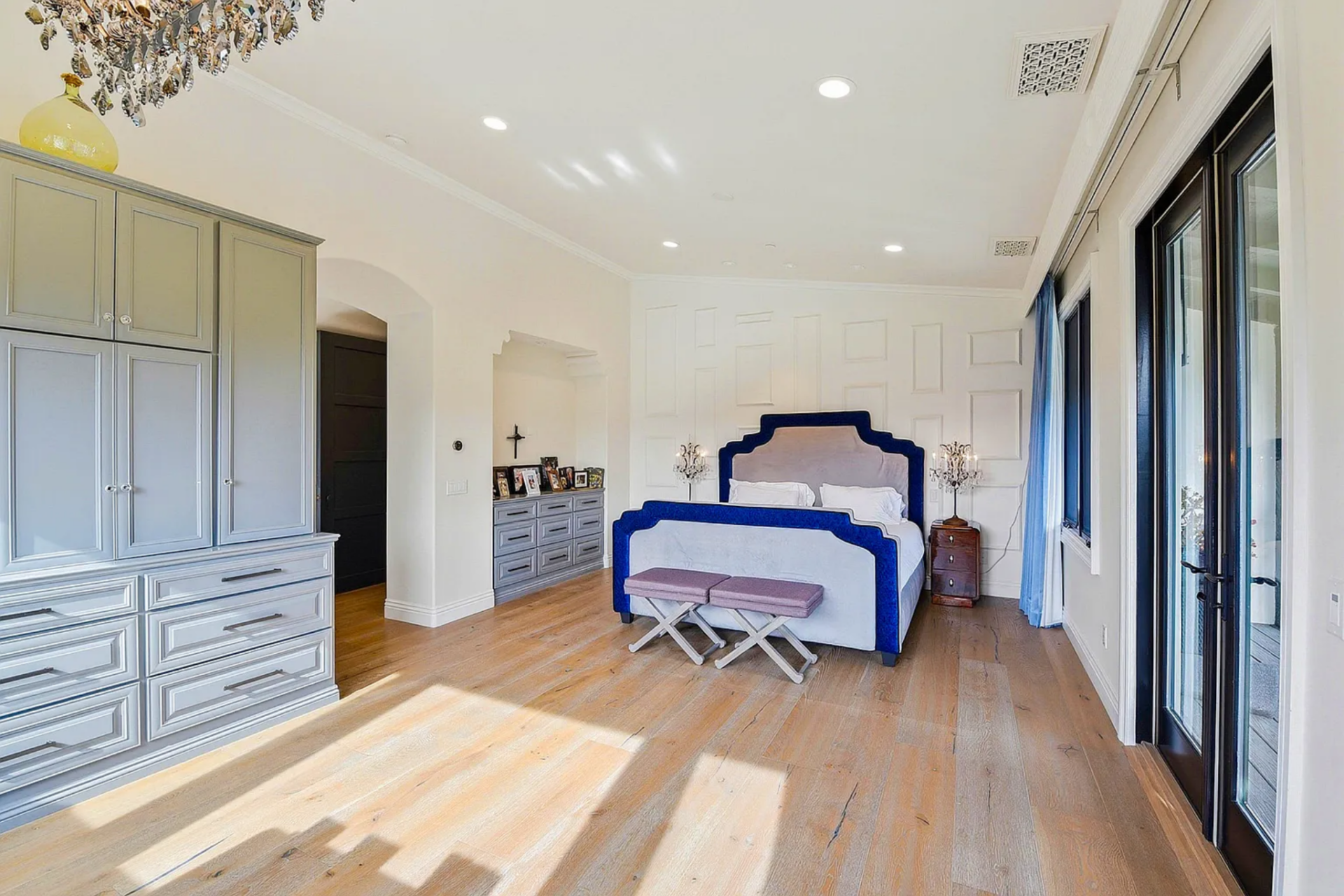 The primary suite is centered around a bedroom that opens directly to its own balcony overlooking the surrounding hills. 