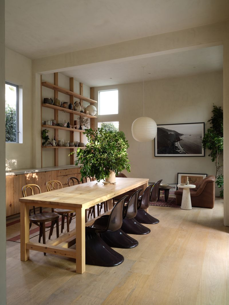 Just around the corner, the kitchen continues the home’s restrained, textural design with Gaggenau appliances integrated into custom wood cabinetry. 
