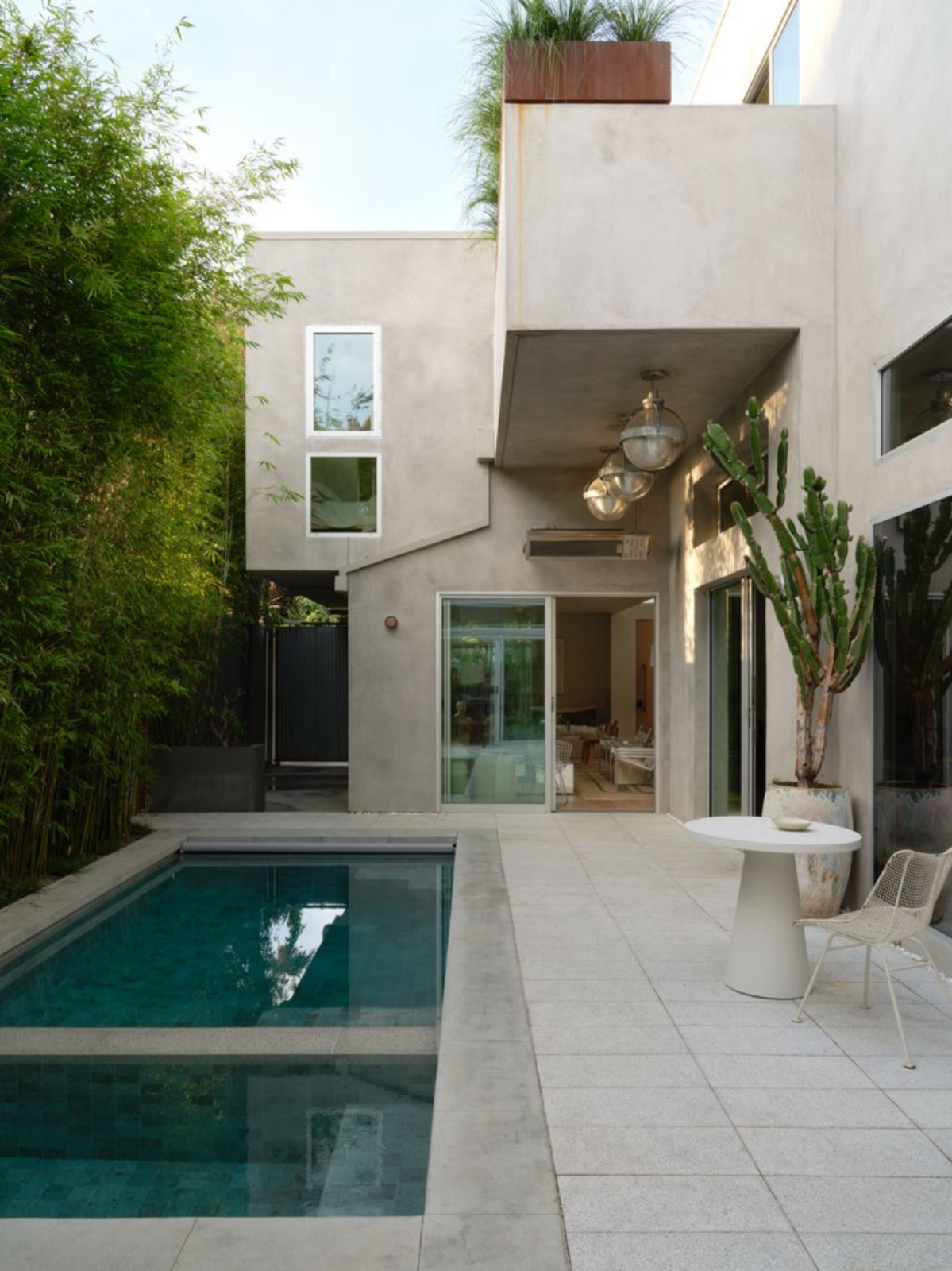 At the center of the home, the heated saltwater pool and spa create a private courtyard accessed through floor-to-ceiling Fleetwood doors that slide open from the surrounding living spaces. 