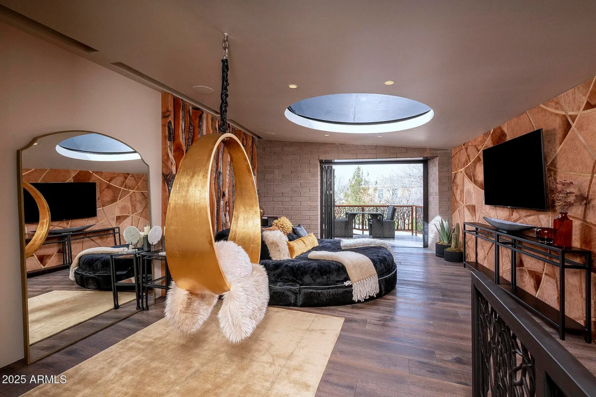 Tucked discreetly within the spa structure, the hidden guest suite includes a circular upholstered bed positioned beneath a large round skylight.