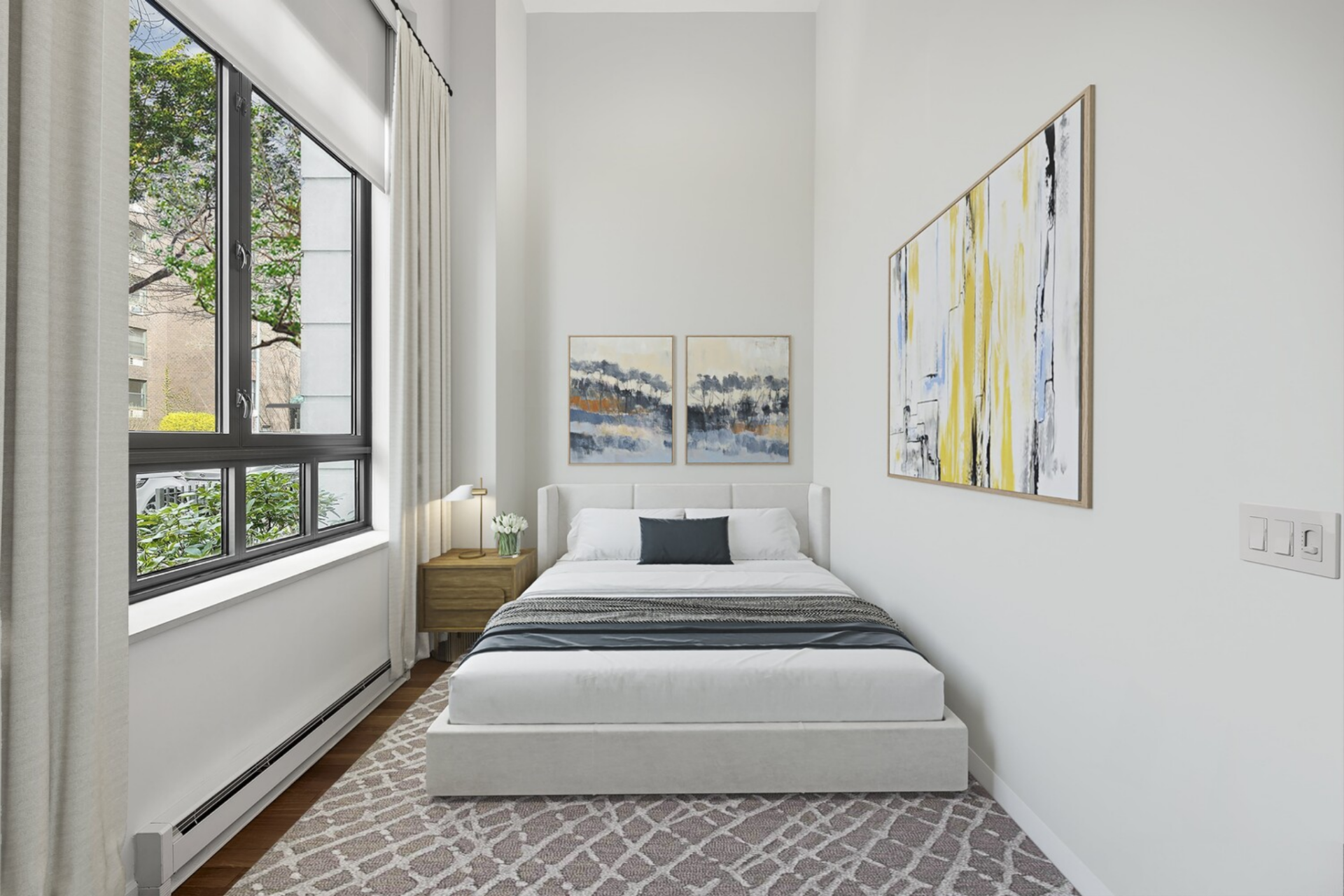 The most streamlined of the three, this bedroom offers a straightforward layout with a centered bed wall and a single window looking at the surrounding buildings.