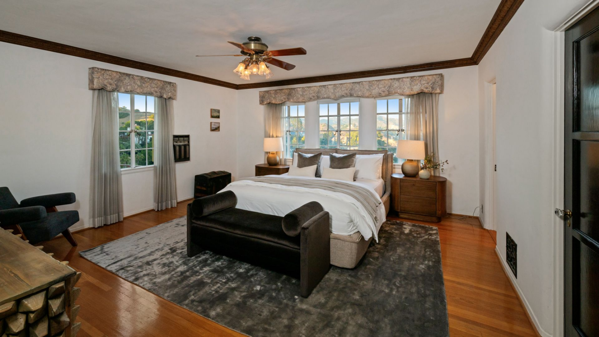 The second bedroom takes a more traditional approach, with the bed centered beneath a trio of windows that overlook the surrounding hills.