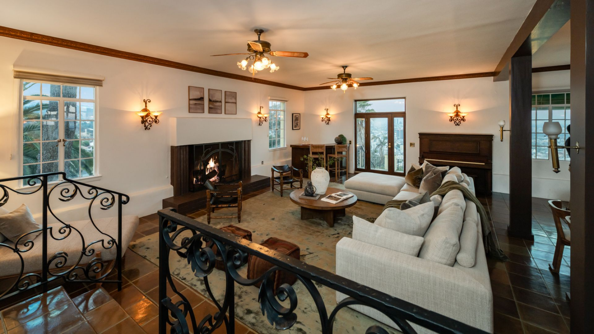 The hearth is framed in dark wood, with a raised platform extending along the base, giving the fireplace weight against the long white wall.