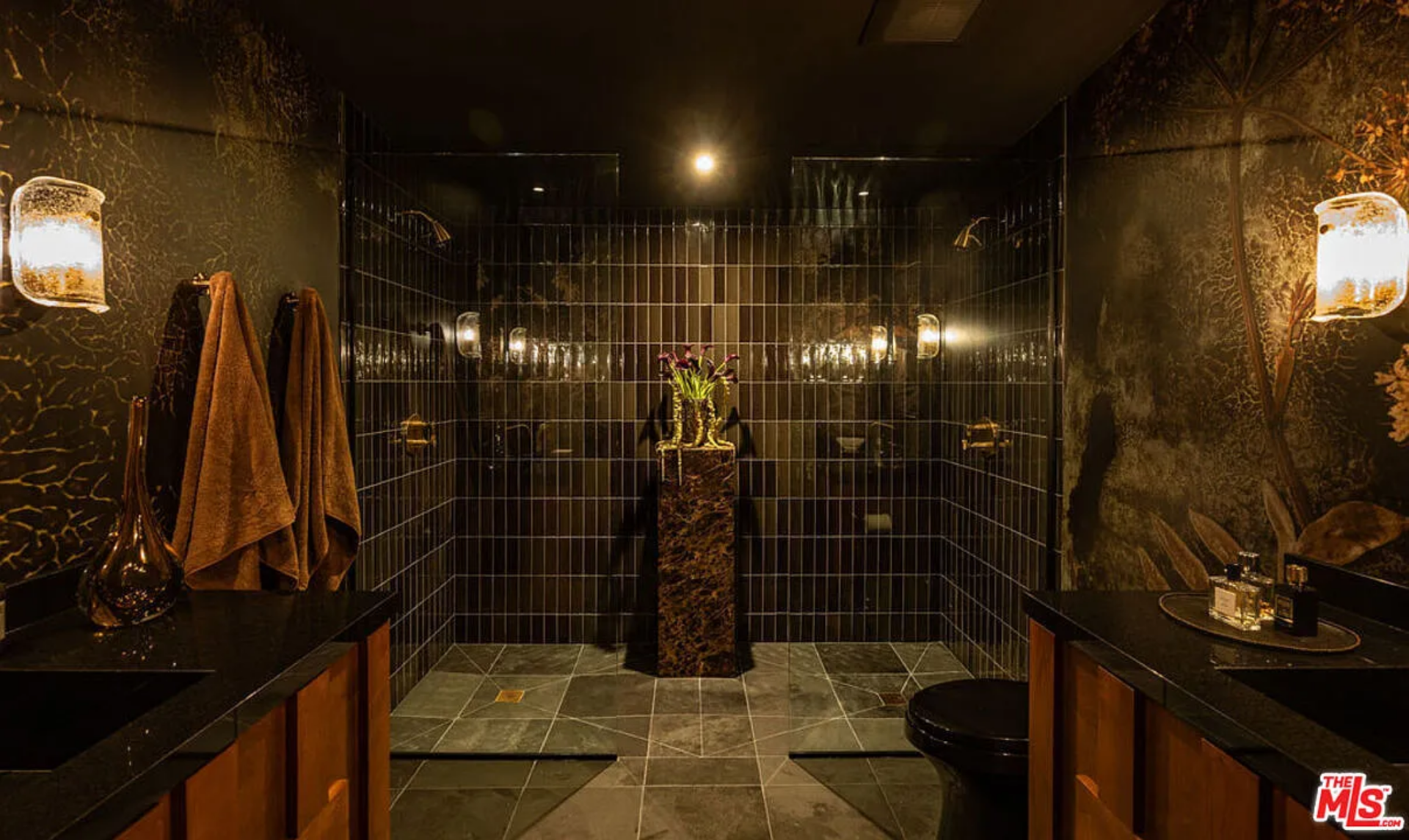 Deep-toned tile wraps the shower walls in a precise grid, creating a symmetrical backdrop that stretches from floor to ceiling.