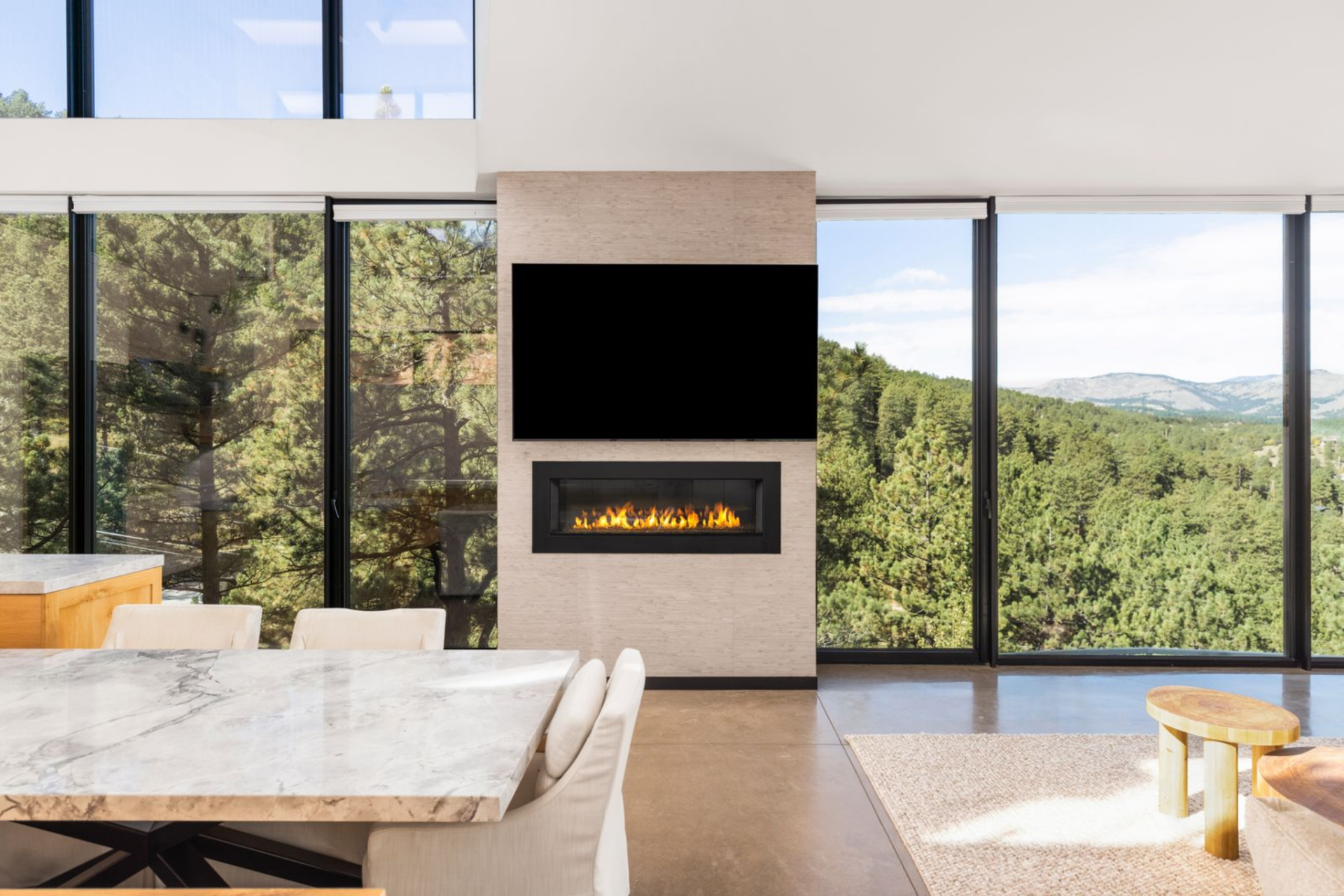 Floor-to-ceiling glass stretches across both the east and west sides of great room, pulling in mountain views and natural light from sunrise to sunset. 