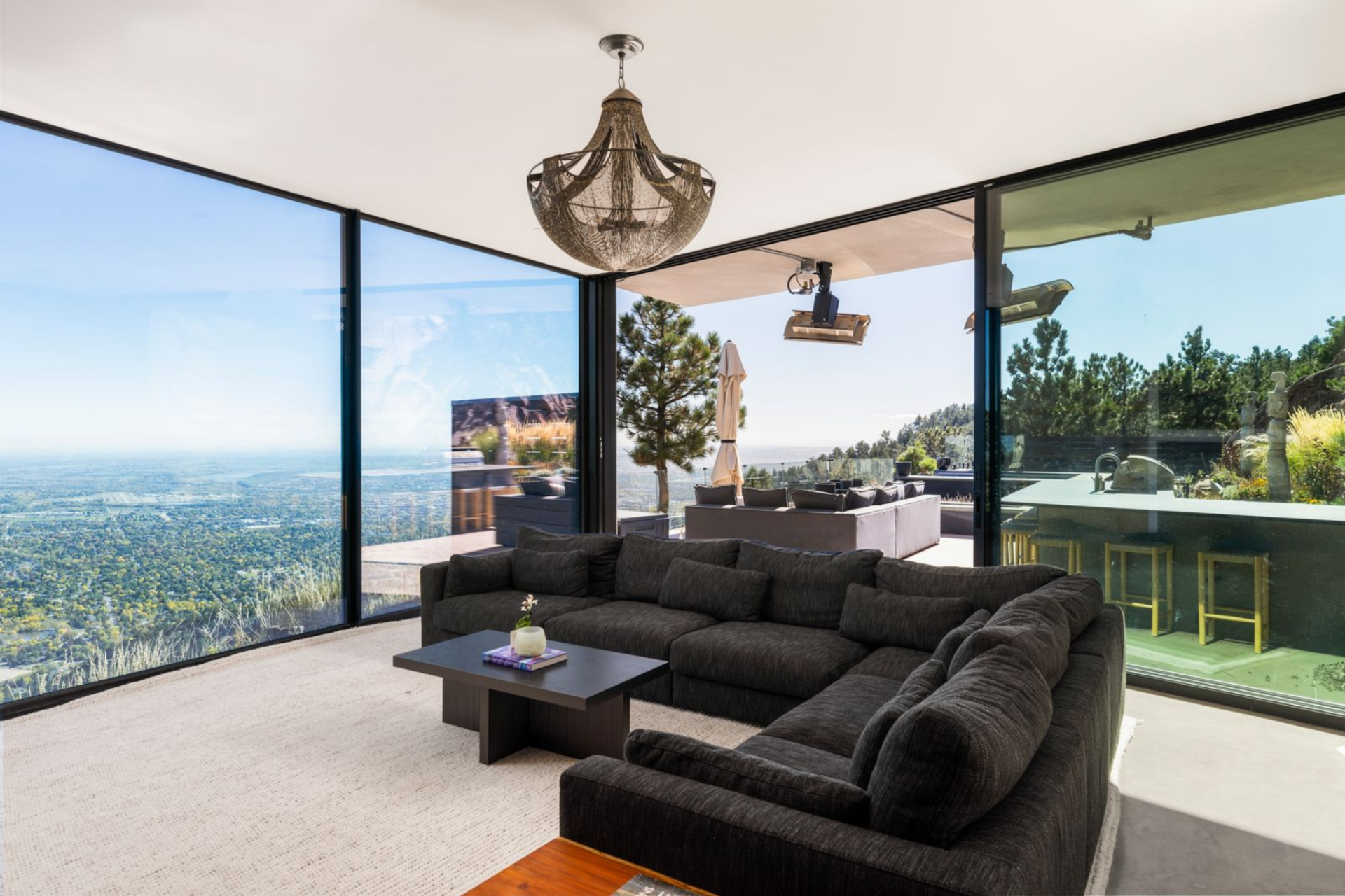 Expansive glass walls open directly to the backyard, allowing the media room to feel like an extension of the landscape.