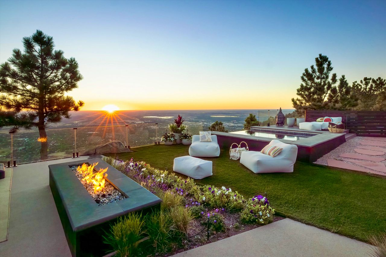 Outdoor heaters and a fire pit lounge extend the terrace’s usability into cooler evenings, while the open layout keeps views front and center.
