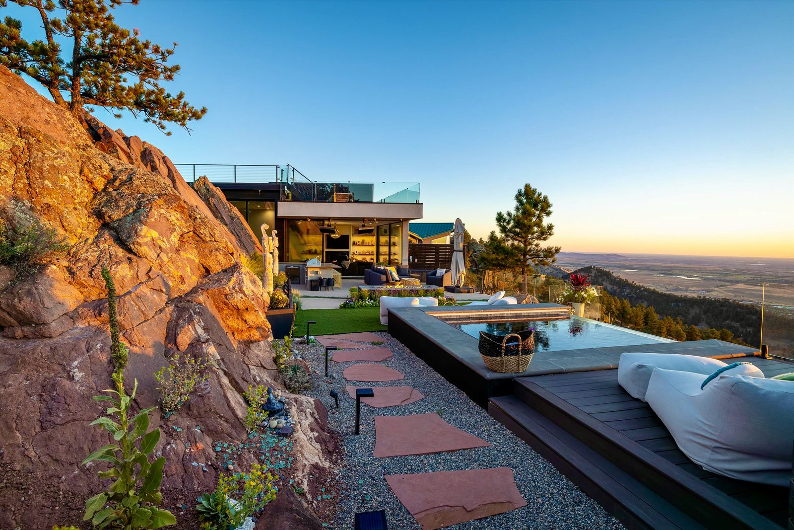 The main terrace serves as the home’s primary outdoor living area, featuring an infinity-edge pool that appears to hover above Boulder Valley. 