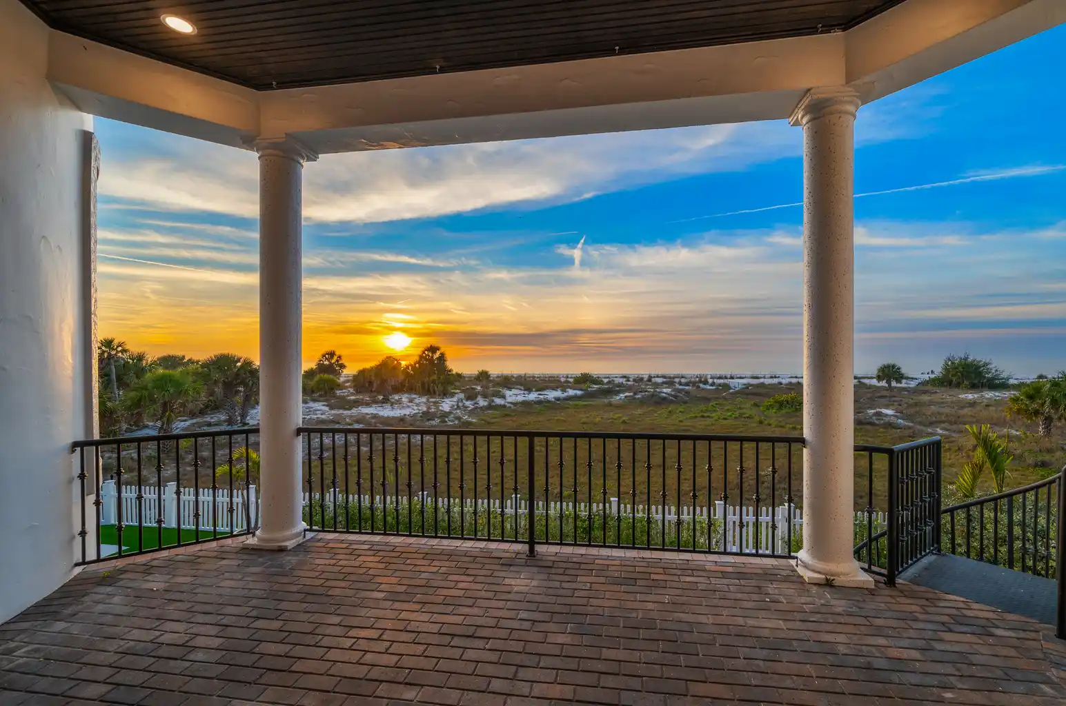 Brick lined terrace extends from living room.
