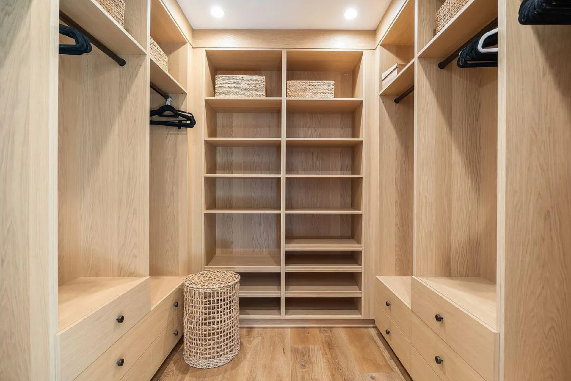 Tucked just beyond the bathroom, the walk-in closet is fully built out in matching light wood.