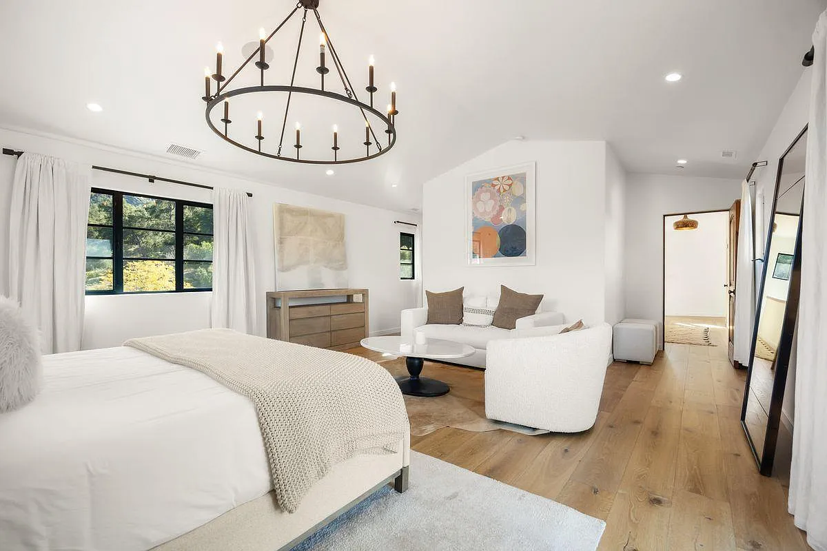 White walls keep the room clean and minimal, allowing the furniture and architectural details to stand out without visual clutter.
