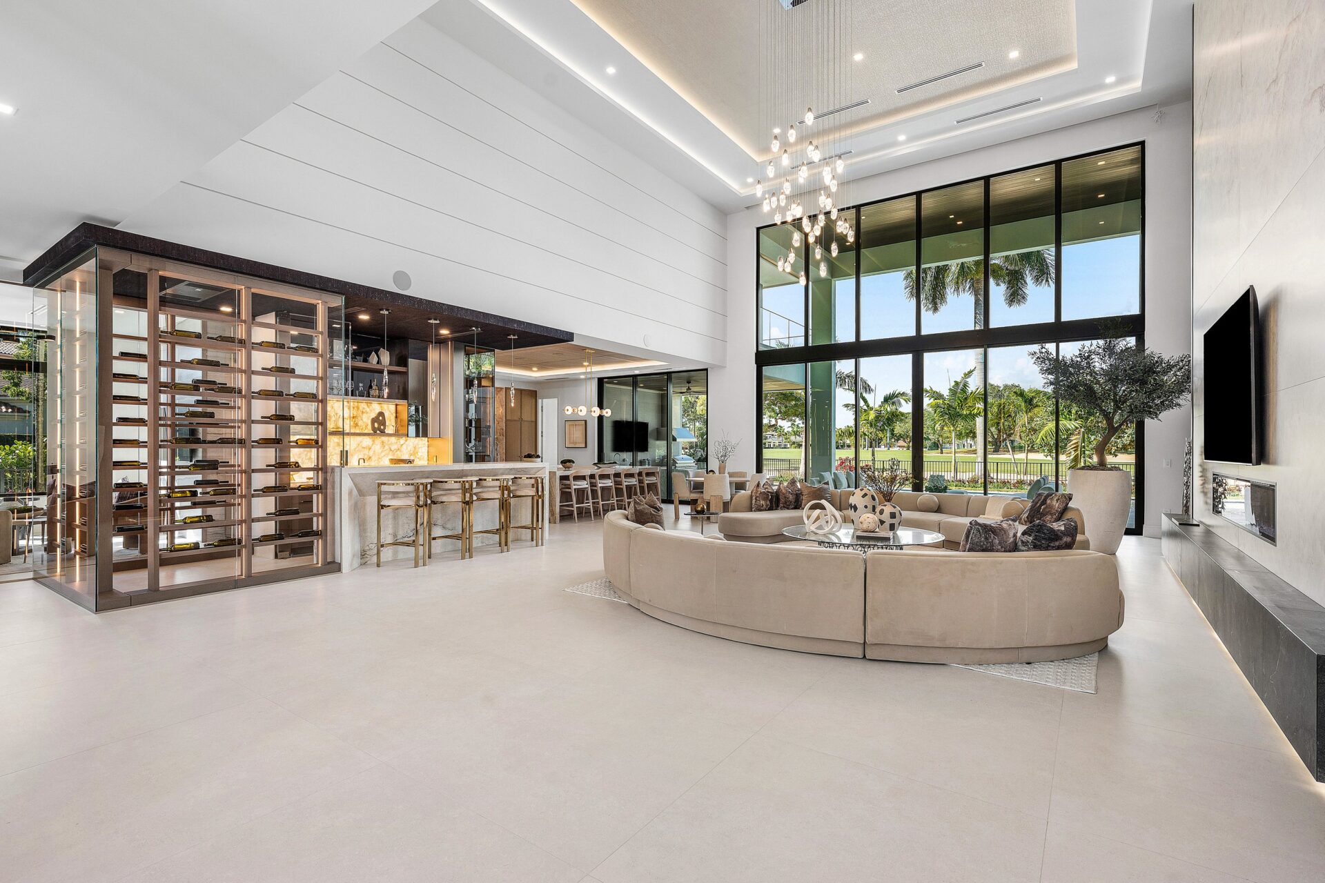 On the other side, a climate-controlled glass wine room and built-in bar are worked directly into the open plan.