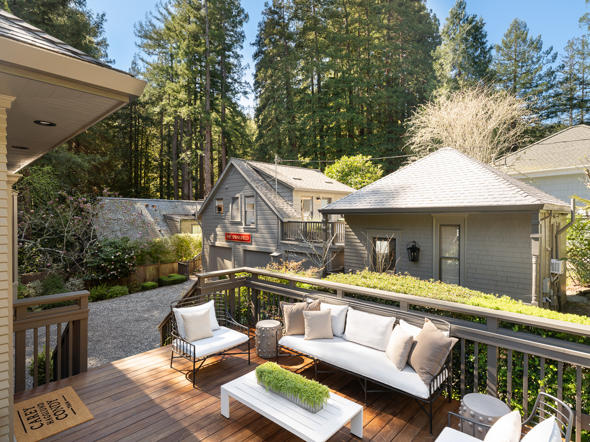 Outdoor patio off the main house with a view of the Carriage House and detached Cottage.