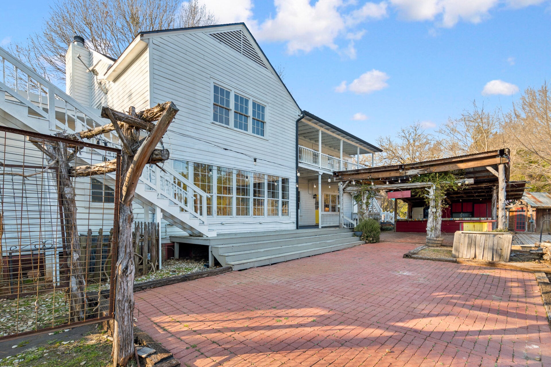 Just off the main residence, the outdoor patio opens into a large brick courtyard that stretches across more than 2,500 square feet of combined covered and open-air living space. 