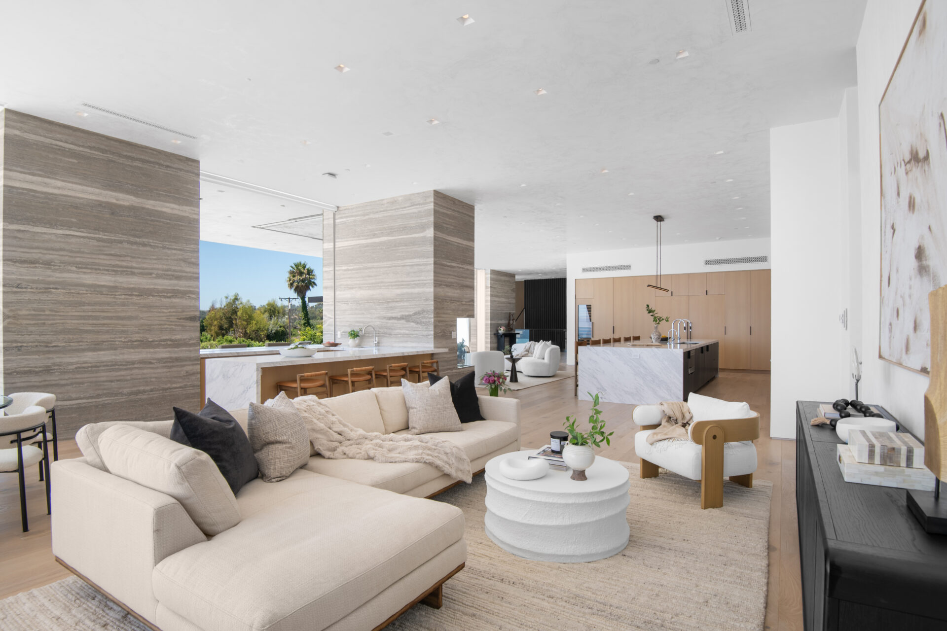 Also within the great room, the family room adds another seating area with a large sectional, a lounge chair, and a low coffee table