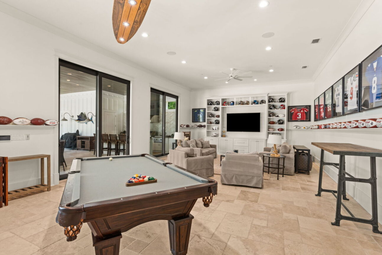 There is also a spacious game room with a pool table, a lounge area, and a large TV providing space to play, relax, and watch games. 